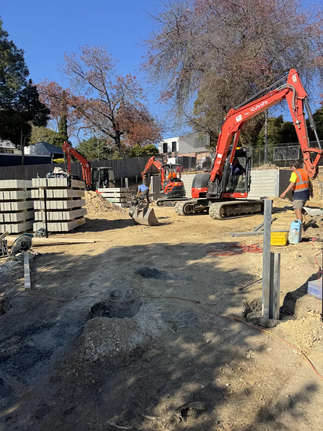Align Excavation Group crew and excavator on site building a concrete sleeper retaining wall