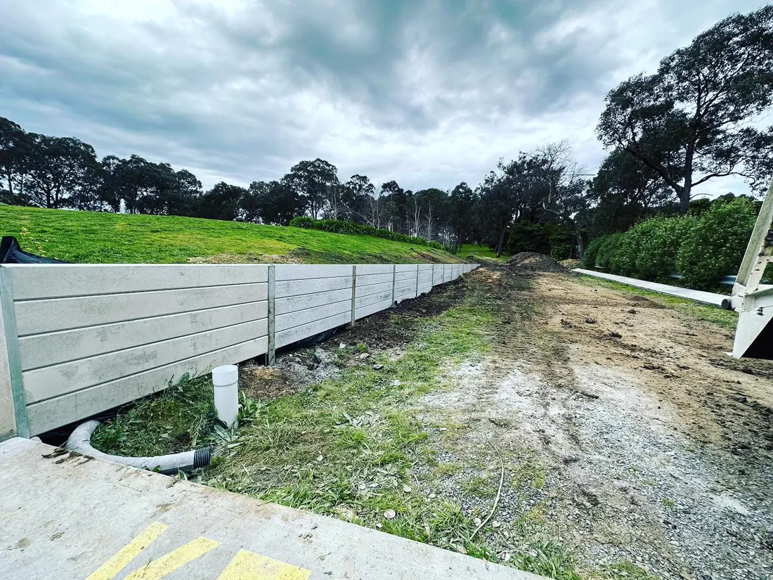 Completed sleeper retaining wall along a slope